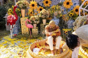 haldi-stage-yellow-drapes-flower-arrangement